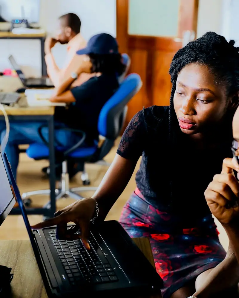 Team collaborating on a project at a computer