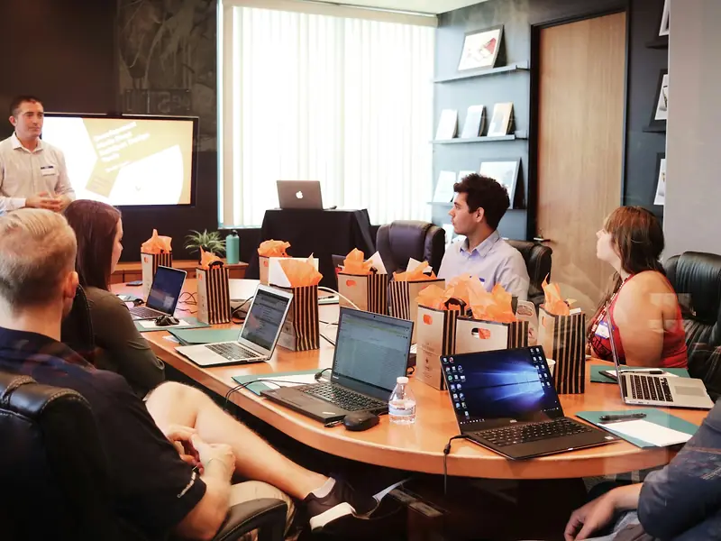 Students learning in a training session with laptops